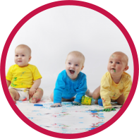 Three cute babies playing with paint